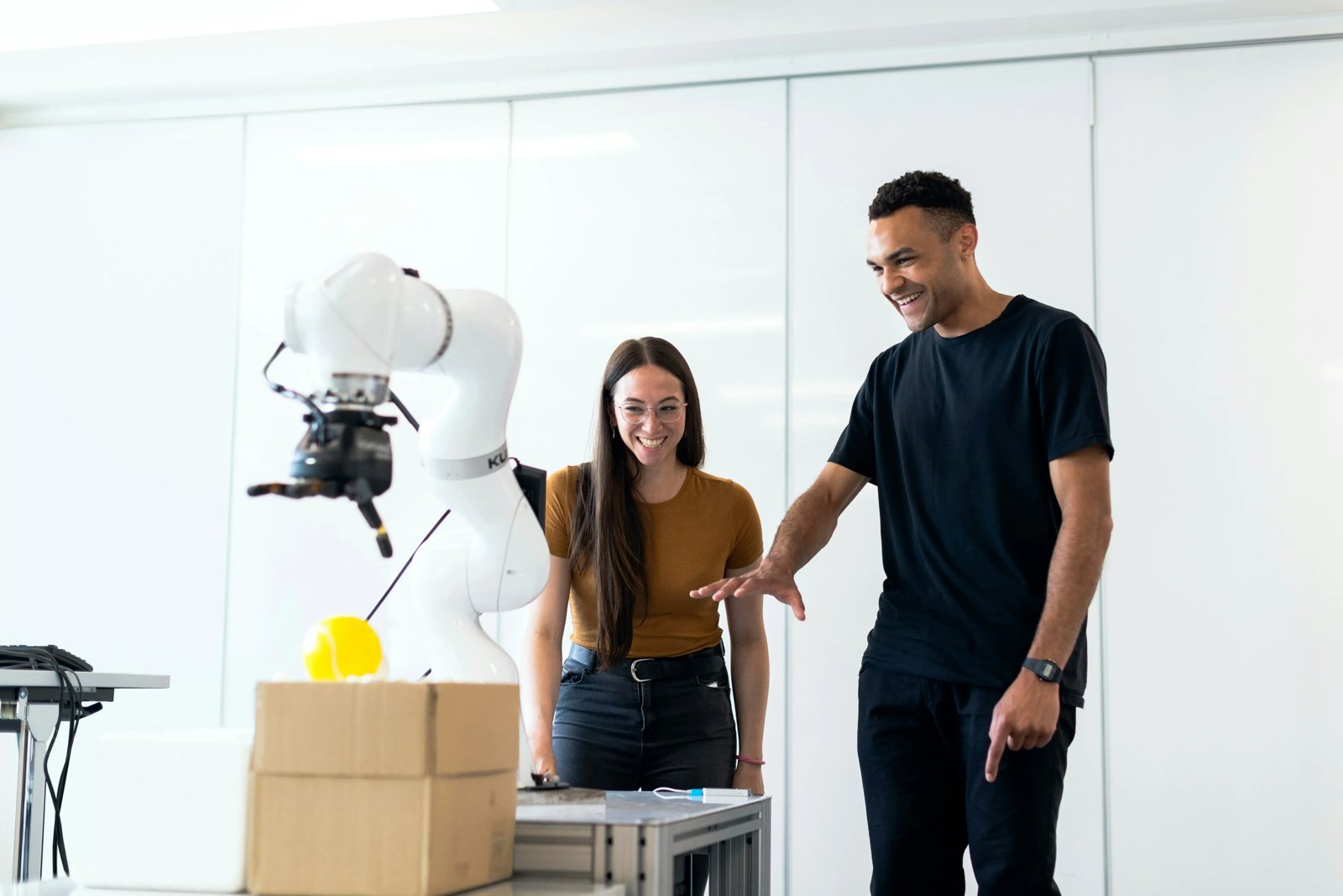 Students working with a robotic arm in a robotics engineering lab