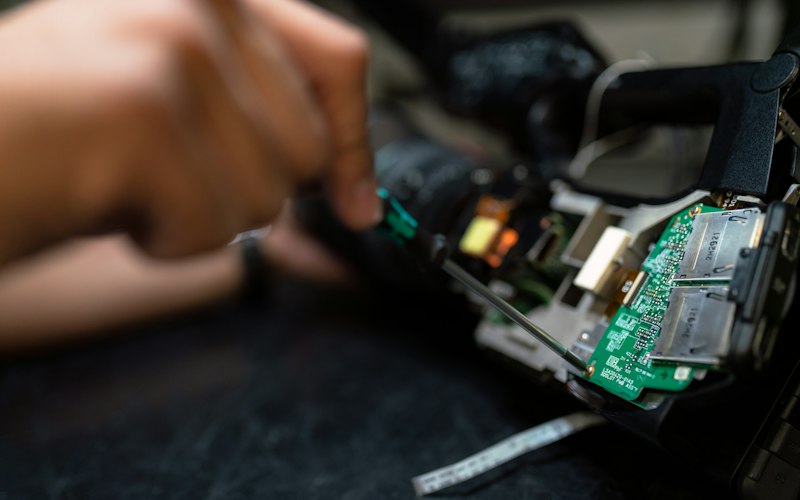 Engineer soldering components on an embedded circuit board